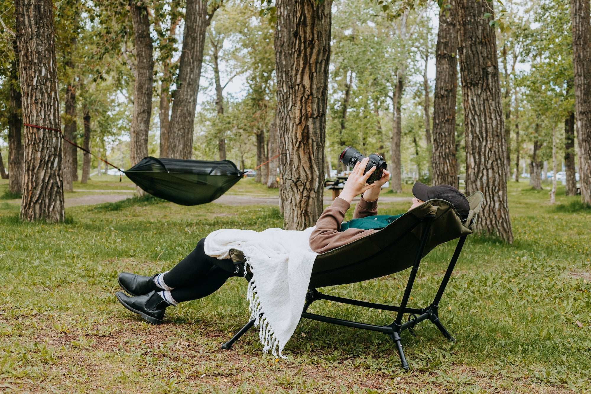 Lightweight and durable camping lounge chair in a forest setting, perfect for outdoor adventures.